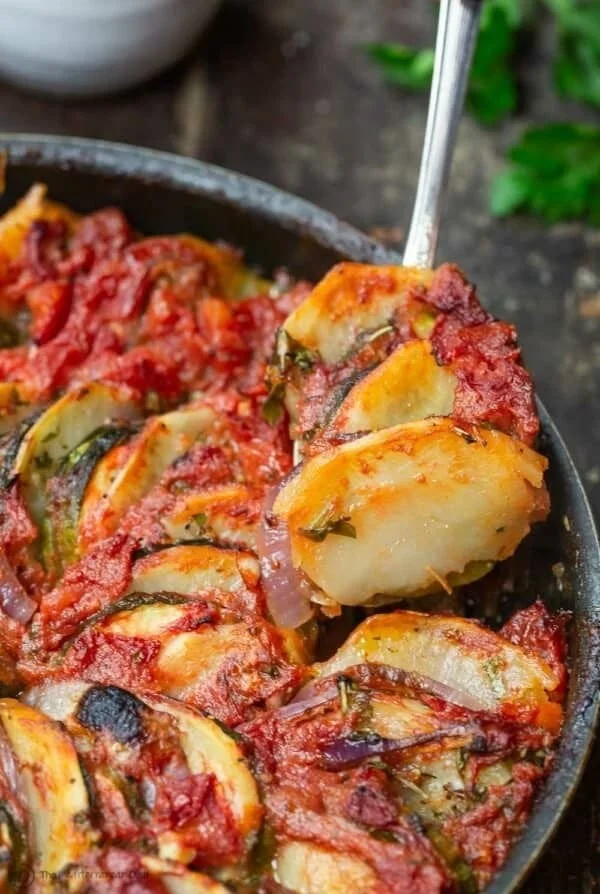 Briam traditional Greek roasted vegetables beautifully arranged on a plate