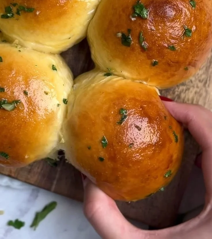 Fluffy garlic butter rolls on a serving plate, ready to enjoy.