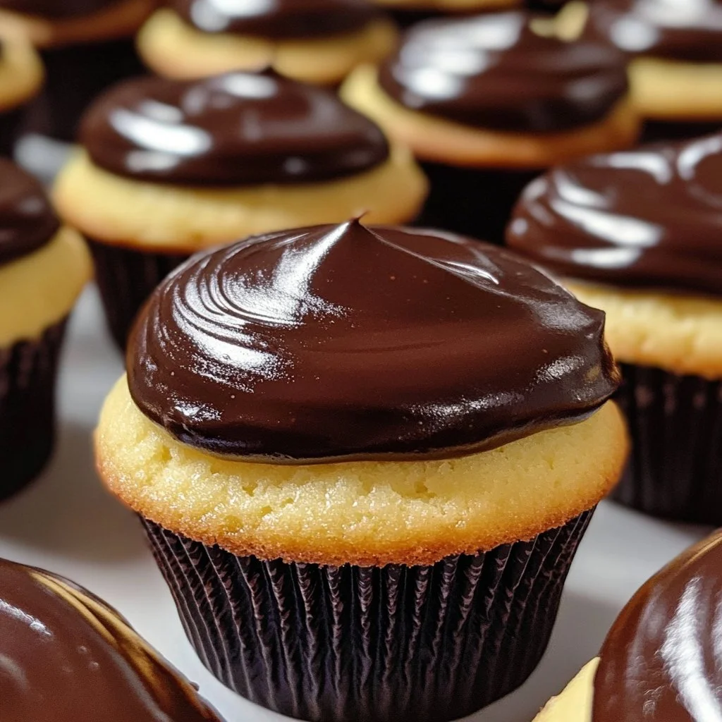 Delicious Boston Cream Cupcakes topped with chocolate and creamy filling