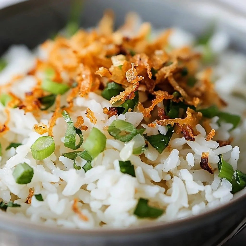 Bowl of Coconut Ginger Rice garnished with fresh herbs and spices.
