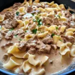 Delicious Ground Beef Stroganoff served with noodles and garnished with parsley