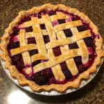 Homemade razzleberry pie with a flaky crust and berry filling
