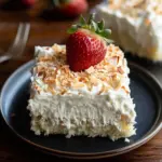 Delicious Keto Poke Cake topped with creamy frosting and berries