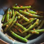 Freshly cooked simple green beans served on a plate.