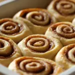 Freshly baked bread machine overnight cinnamon rolls topped with icing.