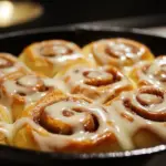 Delicious overnight sourdough cinnamon rolls topped with icing