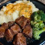 Delicious steak bites with broccoli and cheese on a plate