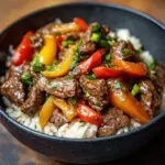Delicious Beef and Pepper Rice Bowl with colorful vegetables and tender beef