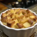 Delicious homemade bread pudding topped with vanilla sauce