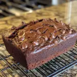Delicious chocolate banana bread sliced and served on a wooden board