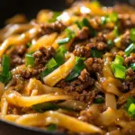 Delicious Mongolian ground beef noodles served in a bowl with fresh vegetables
