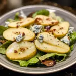 Fresh Pear and Blue Cheese Salad with walnuts and greens on a plate