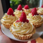 Delicious white chocolate mousse tartlets served on a decorative plate.