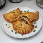 Homemade beef and cheese empanadas served on a plate