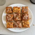 Delicious Carrot Cake Coffee Cake topped with cream cheese frosting and walnuts