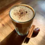 Cinnamon Date Smoothie in a glass with spices and dates