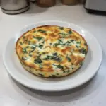 Cottage cheese and spinach crustless quiche served on a white plate