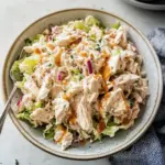 Bowl of Cottage Cheese Chicken Salad with vegetables and herbs