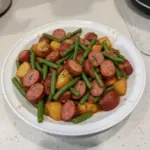 Delicious Crockpot Kielbasa served with green beans in a slow cooker dish