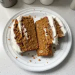 Delicious dairy free carrot cake banana bread sliced on a wooden board.