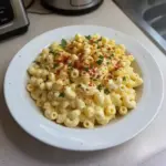 Delicious deviled egg macaroni salad served in a bowl with garnishes