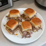 Delicious French Dip Sliders served with au jus sauce.