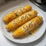 Delicious garlic butter and cheese corn on the cob served as a side dish
