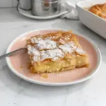 Delicious Greek Bougatsa filled with cream and topped with powdered sugar