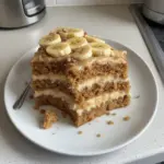 Healthy banana cake slice with fresh bananas and nuts on a plate