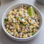 Healthy street corn salad featuring corn, Greek yogurt, and fresh veggies.