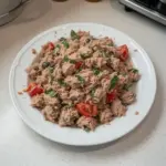 Bowl of Italian tuna salad with fresh vegetables and herbs