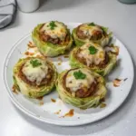 Oven-baked cabbage burgers served on a plate with fresh toppings