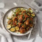 Delicious sheet pan hot honey garlic chicken with zucchini drizzled in hot honey sauce.