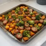 Sheet pan sausage with sweet potatoes and honey garlic sauce ready to serve