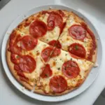 Viral cottage cheese flatbread pizza topped with fresh veggies and herbs.