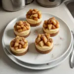 Delicious Apple Crisp Mini Cheesecakes with a crunchy topping and creamy filling