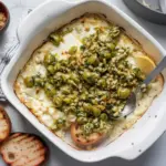 A delicious Baked Feta and Artichoke Dip topped with Olive Gremolata