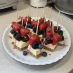 Delicious berry cheesecake dessert kabobs on a platter