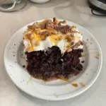 Delicious Better Than Sex Cake topped with chocolate and whipped cream