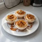 Delicious Biscoff dessert cups topped with crumbled cookies and whipped cream.