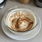 Delicious caramel mousse served in a glass dish with caramel drizzle on top
