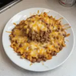 Cheesy hamburger casserole topped with melted cheese and served in a dish