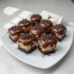 Chocolate chip cookie dough brownie bites on a plate, perfect for dessert lovers.