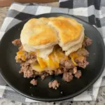 Chopped cheeseburger biscuits served on a plate with toppings