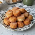 Plate of freshly baked Cinnamon Sugar Biscuit Bites with a dusting of cinnamon