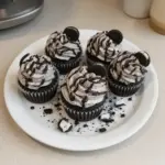 Cookies and cream cupcakes topped with crushed cookies and creamy frosting