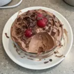 Delicious cottage cheese chocolate mousse served in a bowl with a spoon