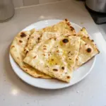Freshly baked Cottage Cheese Naan Bread served with dip