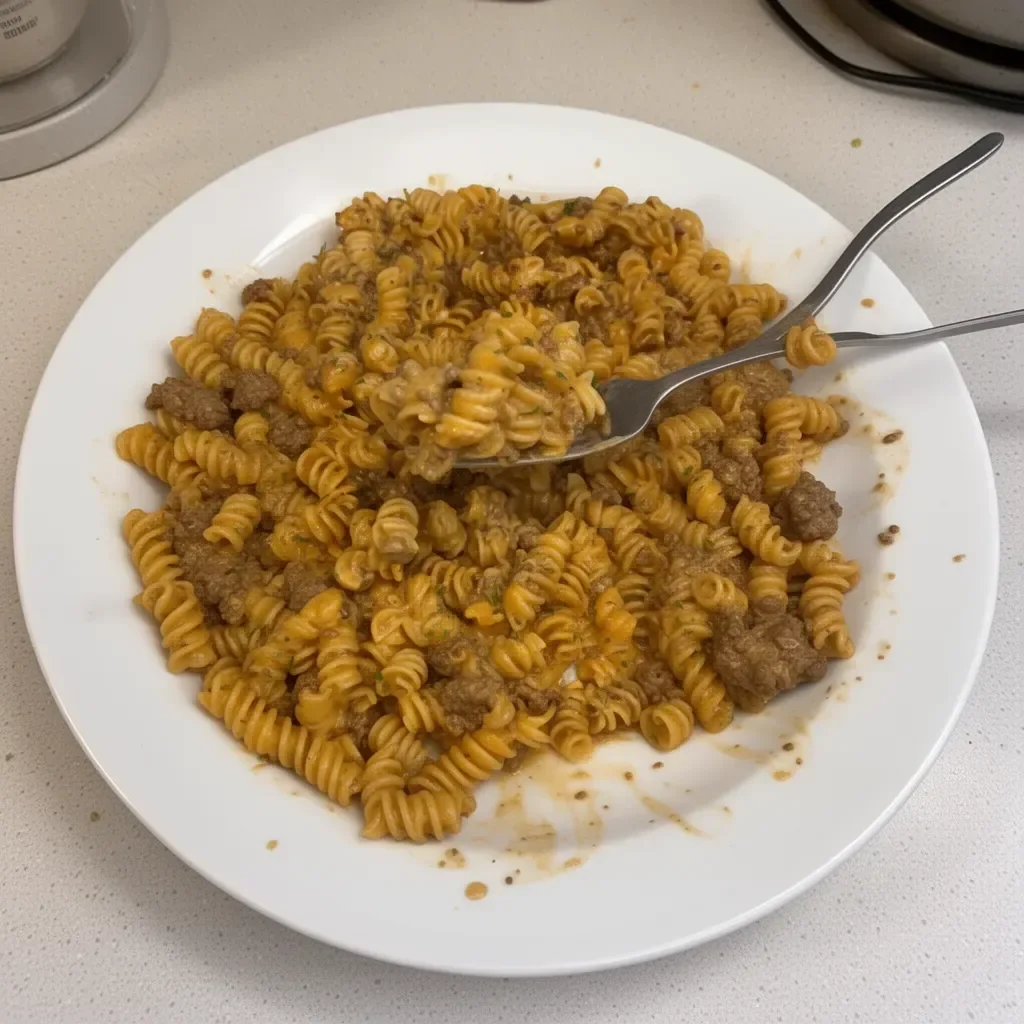 Delicious creamy beef pasta served in a bowl with herbs and cheese