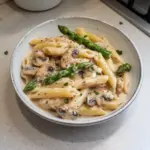 Creamy Mushroom Asparagus Chicken Penne pasta with fresh ingredients in a bowl